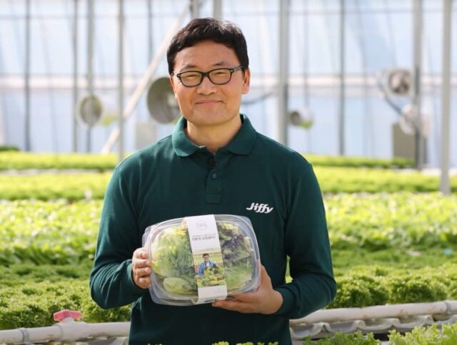 President of Farmers F.D. nursery, holding a box of salad greens