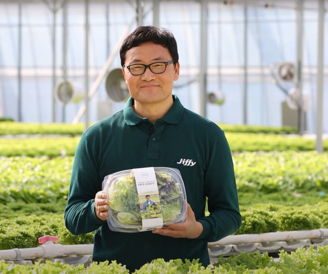 President of Farmers F.D. nursery, holding a box of salad greens